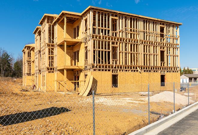 a temporary chain link fence winding around a job site, outlining the project's progress in Medinah, IL